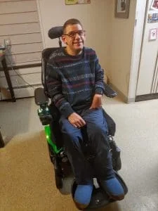 Kevin using his back up powered wheelchair